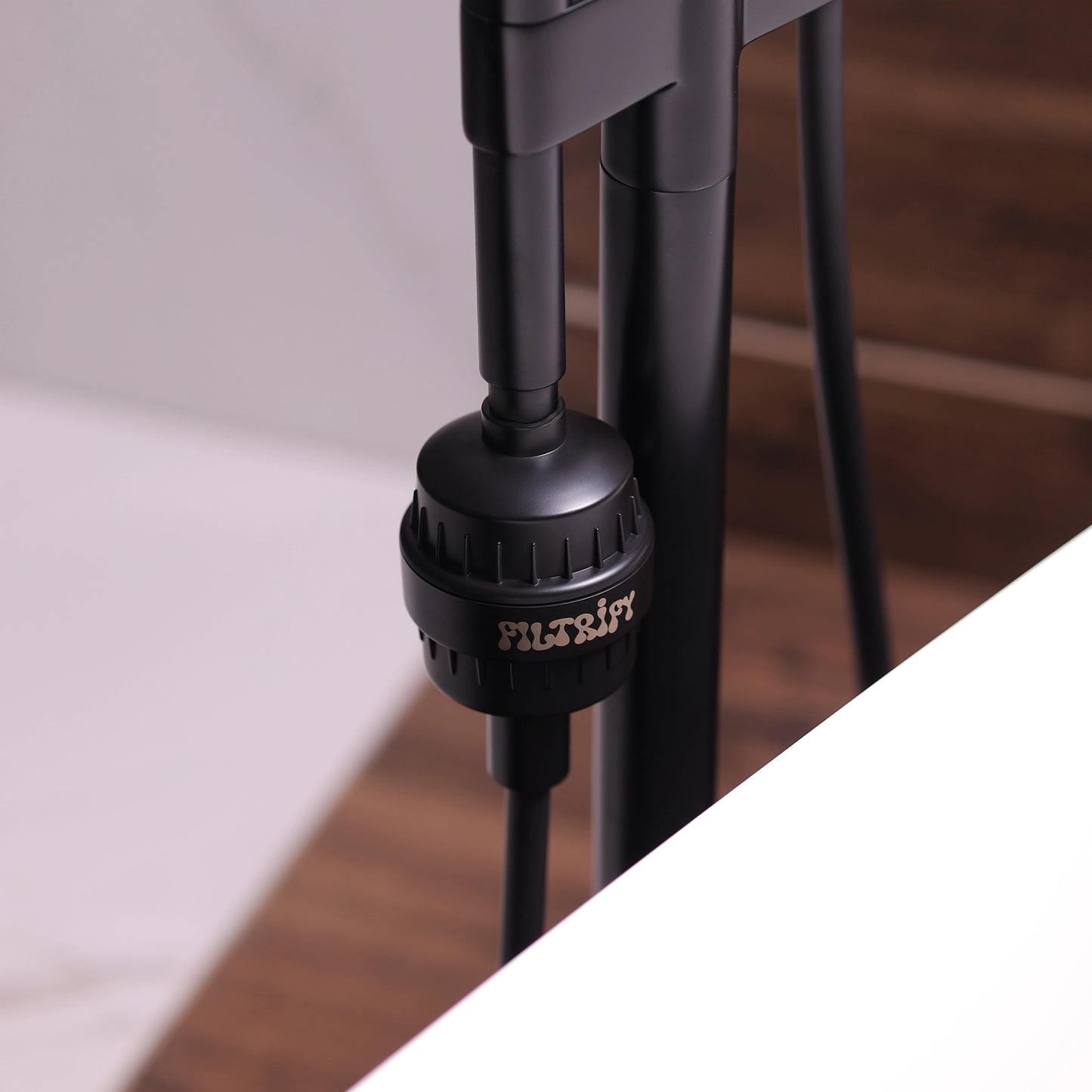 Filtrify jet black shower filter installed on shower hose | variant:jet-black