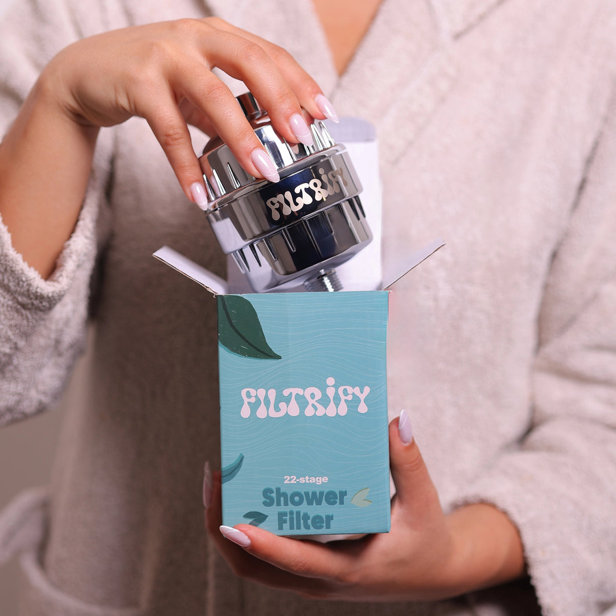 Customer holding Filtrify shower filter